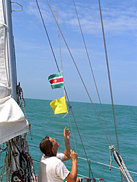 Dory hoists the courtesy flag for Surinam